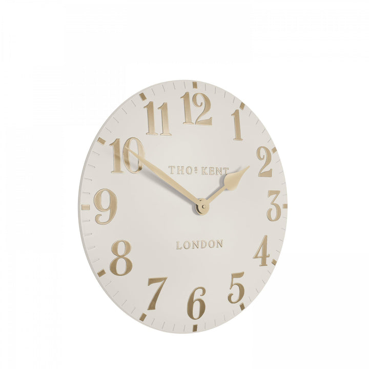 12-inch Arabic wall clock in oatmeal color by Cornucopia Home and Gift, featuring stylish Arabic numerals on a modern clock face.