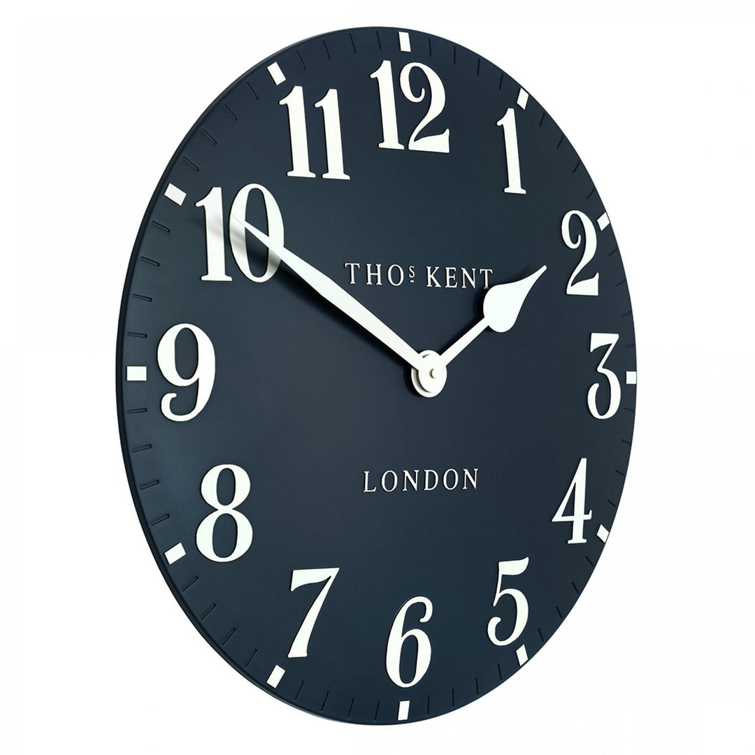 Large 20-inch Arabic ink wall clock with bold black numerals, artistic design, by Cornucopia Home and Gift.