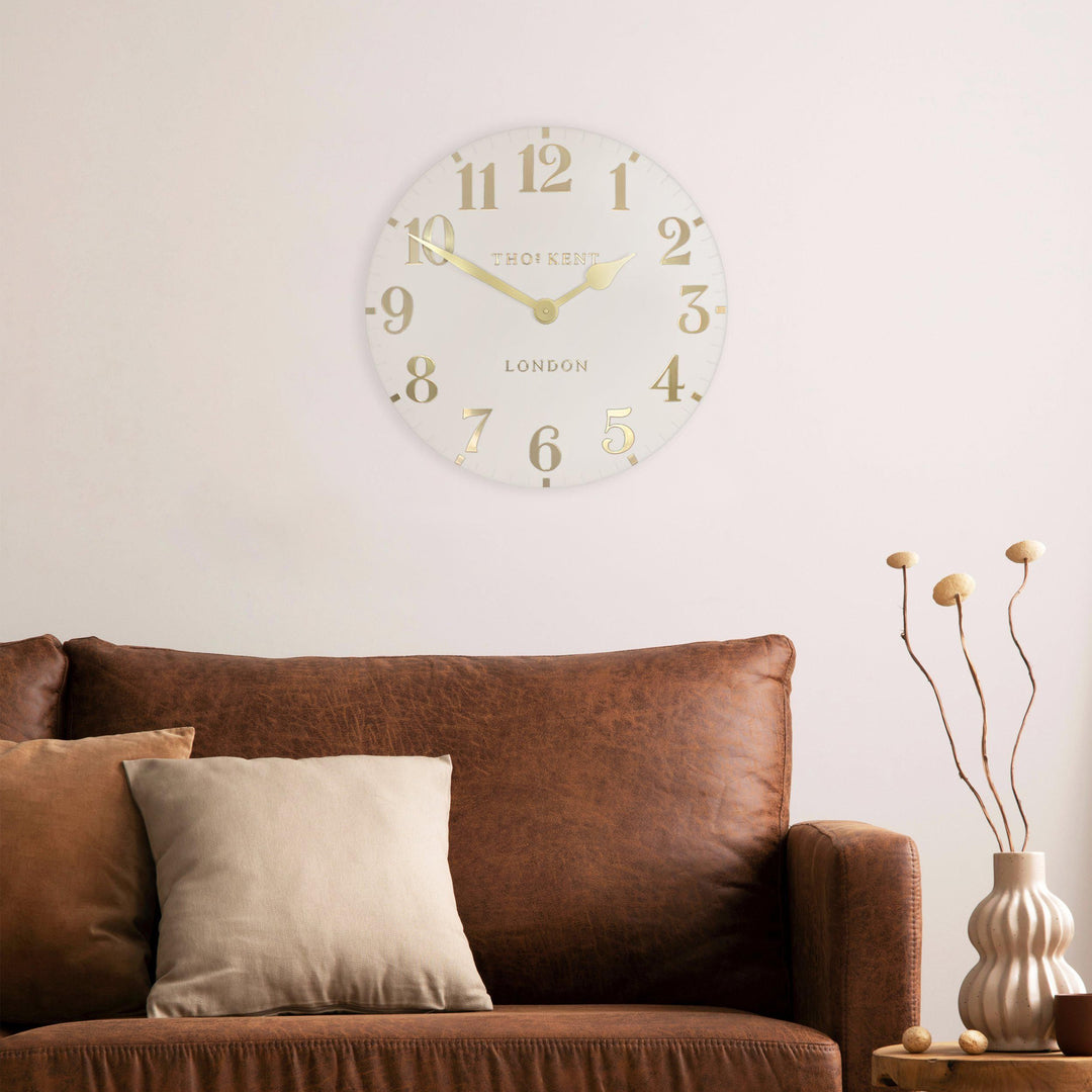 20-inch Arabic wall clock in oatmeal color by Cornucopia Home and Gift, featuring bold Arabic numerals and a modern design.