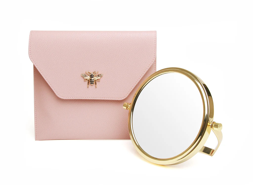 Alice Wheeler pink travel mirror with matching case, compact and stylish for on-the-go grooming and makeup touch-ups.