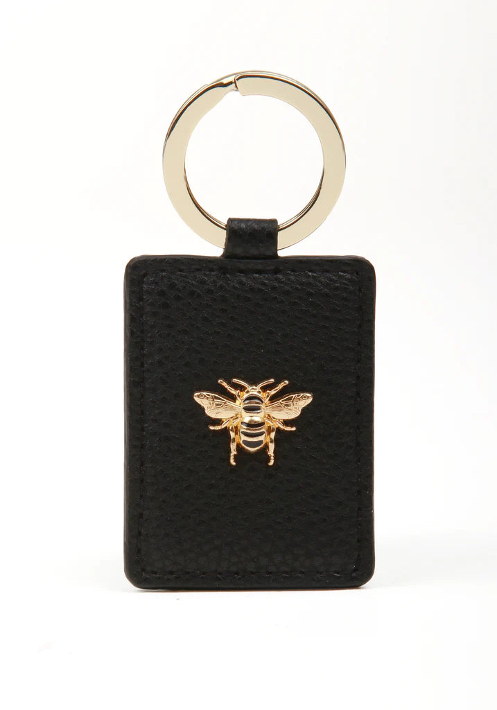 Black Alice Wheeler key ring with silver hardware and engraved logo, featuring a sleek and compact design.