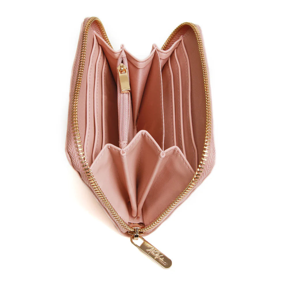Open pink Alice Wheeler Bromley purse with multiple card slots and zipper pocket, showcasing its elegant design and bright color.