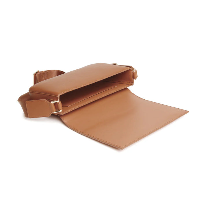 Alice Wheeler Lisbon cross body bag in tan leather with adjustable strap and sleek design, shown with front view.