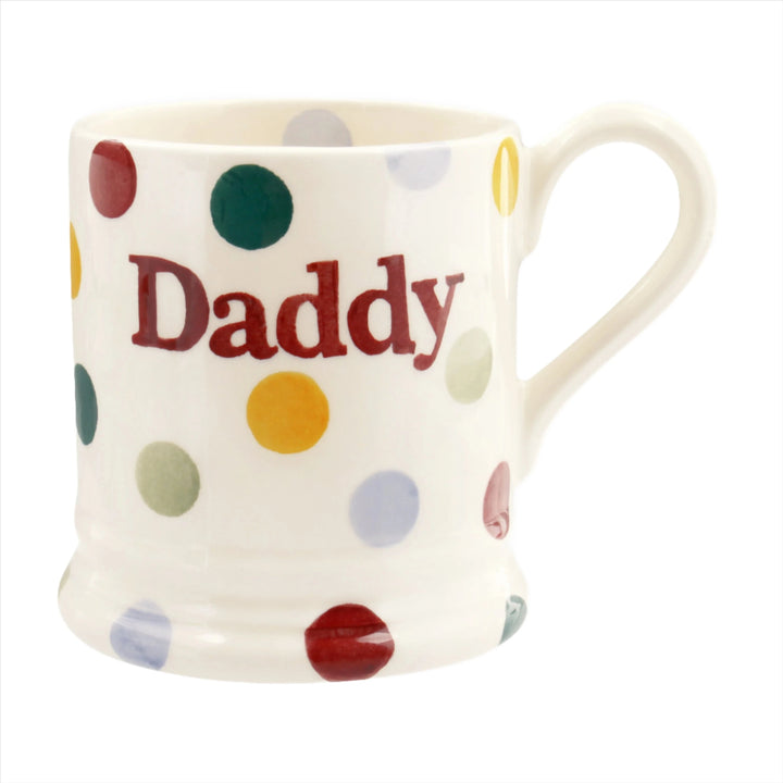 A white ceramic half pint mug with multicolored polka dots and the word &