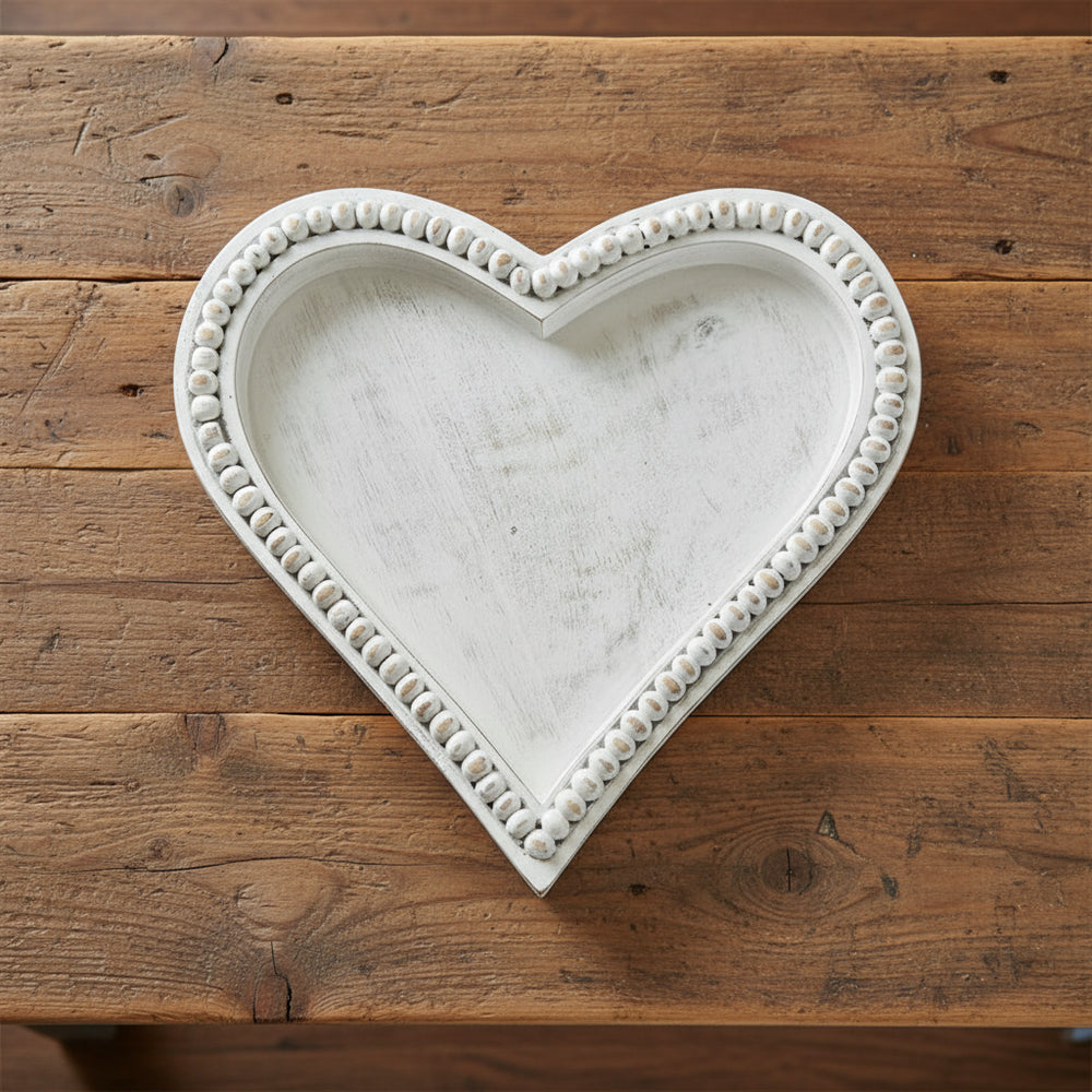 Medium heart-shaped beaded tray made of mango wood by Cornucopia Home and Gift, featuring antique white beaded detailing.