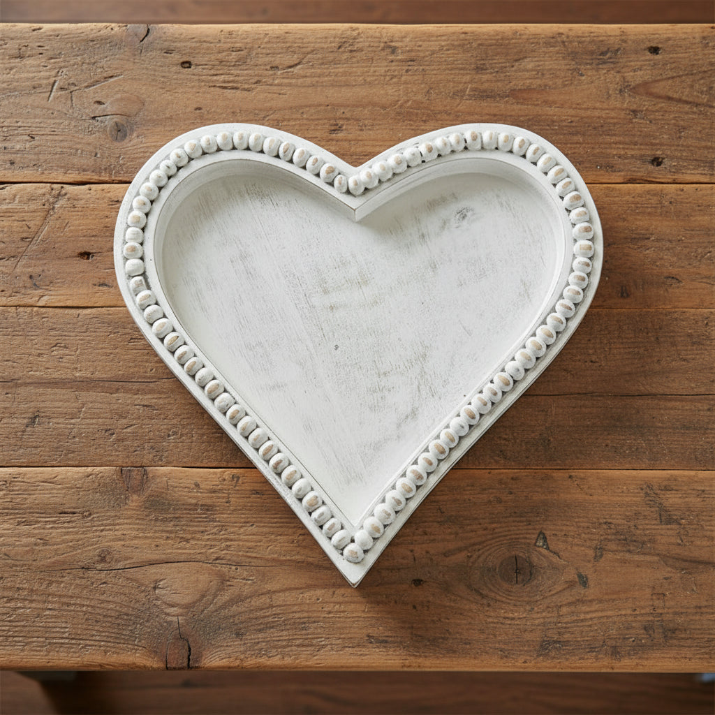 Medium heart-shaped beaded tray made of mango wood by Cornucopia Home and Gift, featuring antique white beaded detailing.