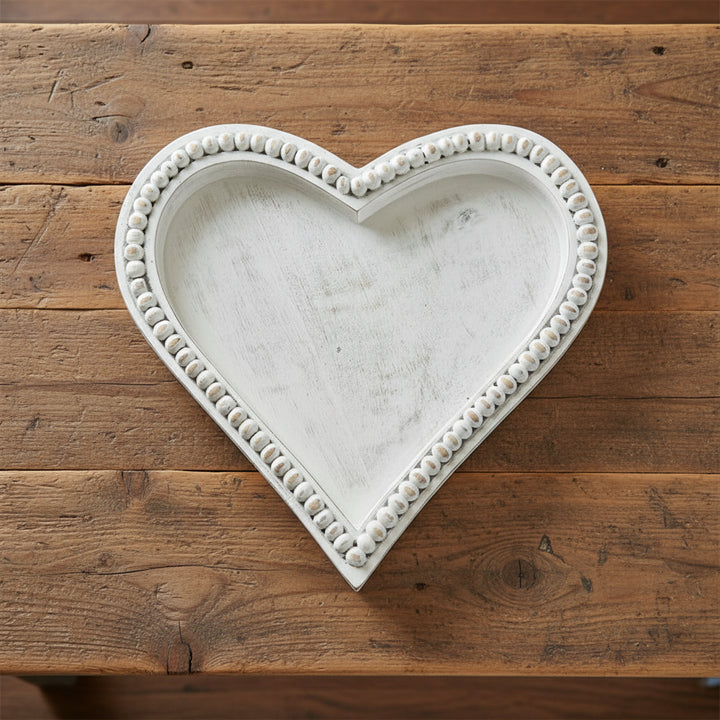 Medium heart-shaped beaded tray made of mango wood by Cornucopia Home and Gift, featuring antique white beaded detailing.