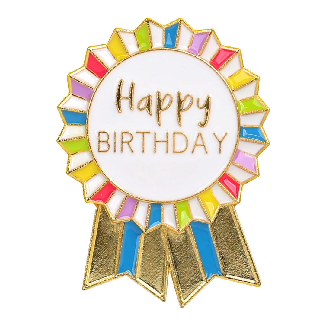 Colorful enamel "Happy Birthday" badge from Talking Tables by Cornucopia Home and Gift, featuring bright, cheerful design.