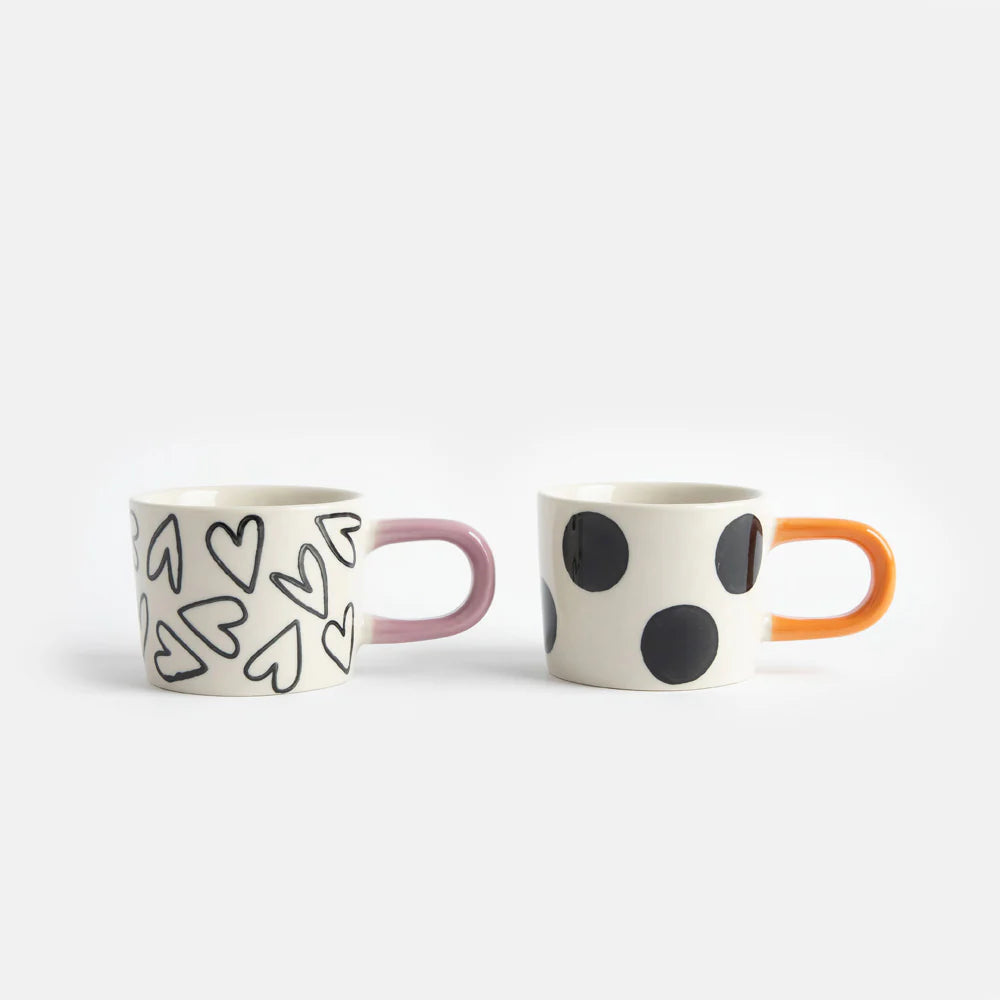 Set of two Caroline Gardner mono spot and hearts espresso cups with stylish designs, perfect for gifting or everyday use.