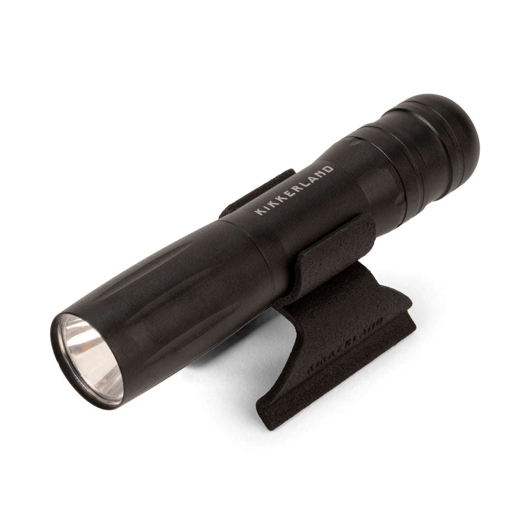 Kikkerland BBQ clamp light with white background, showing a compact, portable LED light designed for grilling and outdoor use.