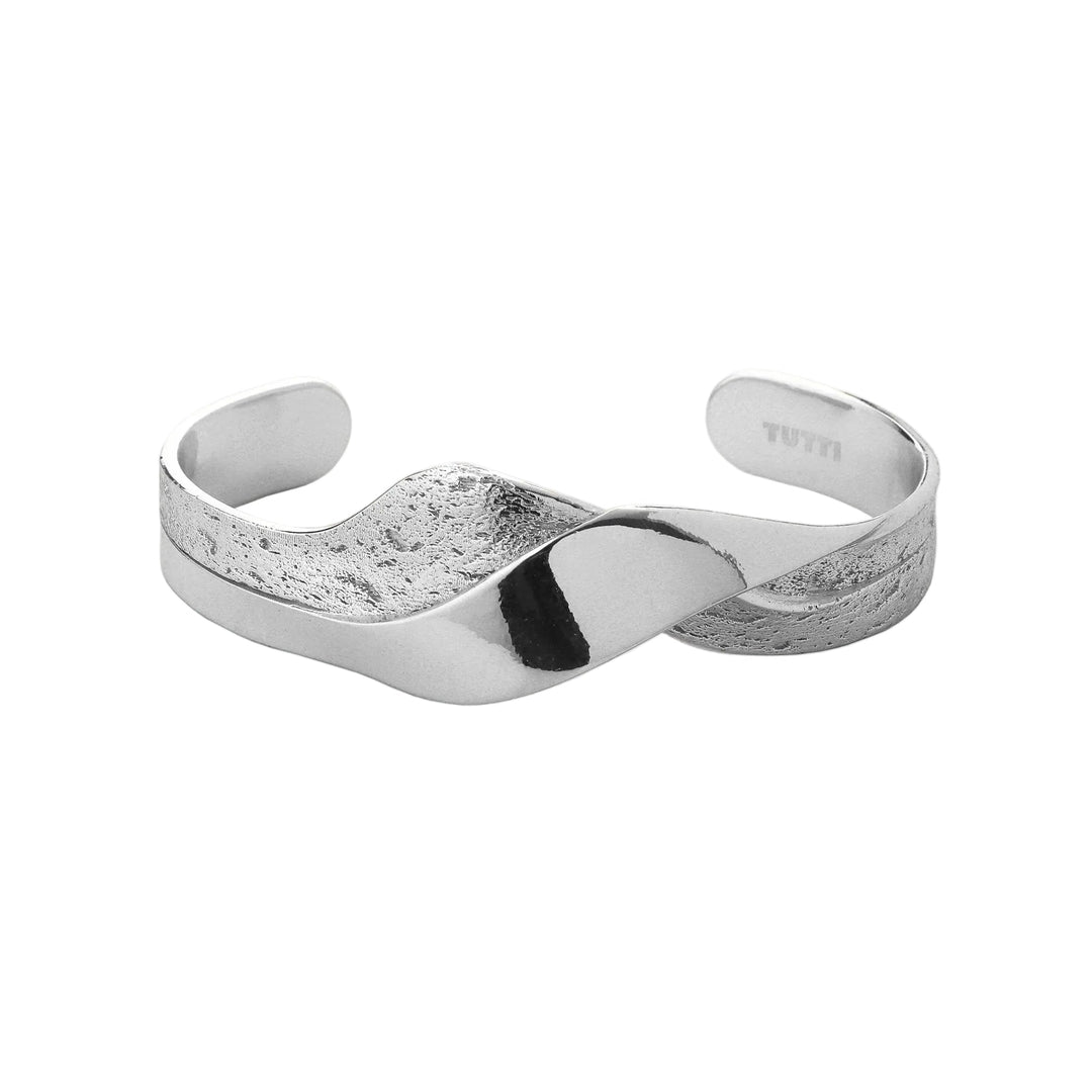 Silver cuff bracelet on a light gray background
