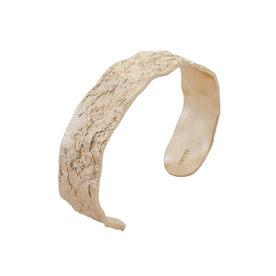 Gold Revere Bangle by Tutti & Co, featuring a sleek, shiny design with smooth curves, perfect for elegant wrist styling.