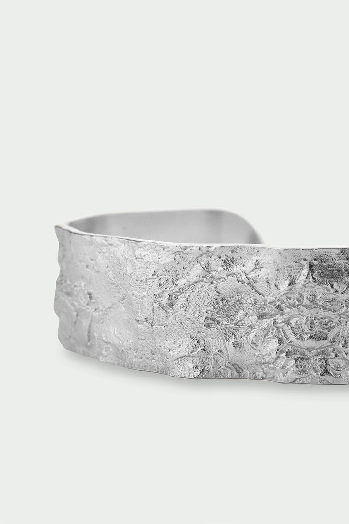 Silver Revere Bangle by Tutti &amp; Co featuring a sleek, modern design, showcased on a neutral background.