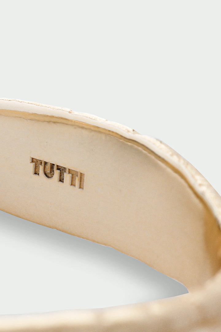 Gold Driftline Bangle from Tutti &amp; Co featuring a sleek, modern design displayed on a neutral background.