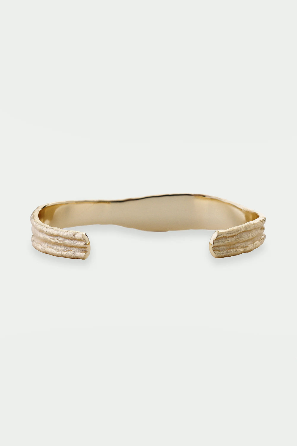 Gold Driftline Bangle by Tutti & Co featuring a sleek, modern design with smooth curves and a polished finish.