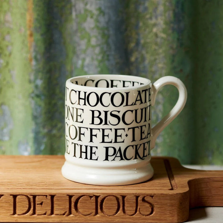 Emma Bridgewater Black Toast all-over writing 1/2 pint ceramic mug with black toast pattern on a white background.