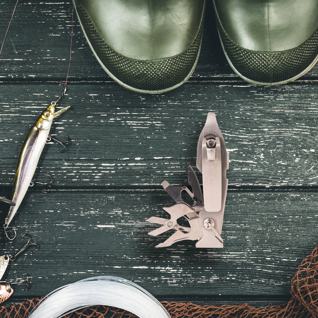 Kikkerland fishing multi-tool with pliers, knife, screwdriver, and bottle opener, compact and versatile for outdoor fishing trips.