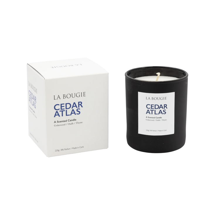 Cedar Atlas Candle by La Bougie from Cornucopia Home and Gift, showing a sleek candle in a decorative container with a lit flame.