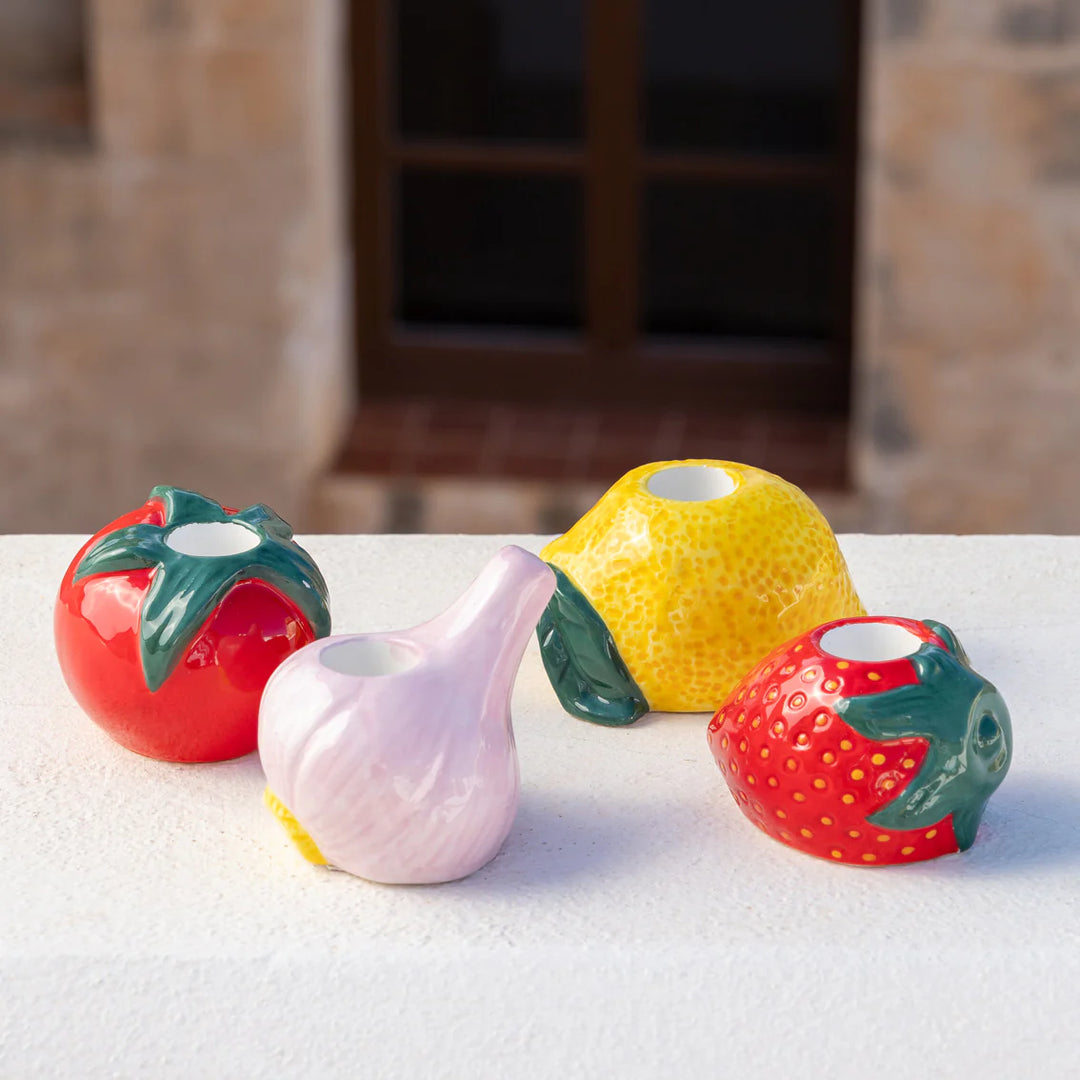 Tomato-shaped ceramic candle holder by Cornucopia Home and Gift, designed for decorative use and ambient lighting.