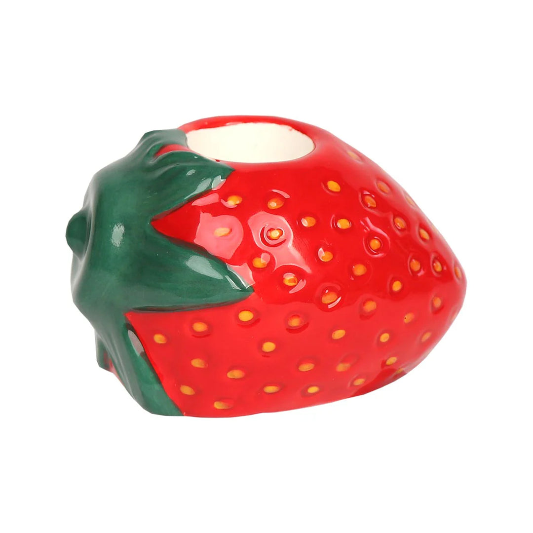 Red strawberry-shaped ceramic candle holder by Cornucopia Home and Gift, perfect for decorative candles and table decor.