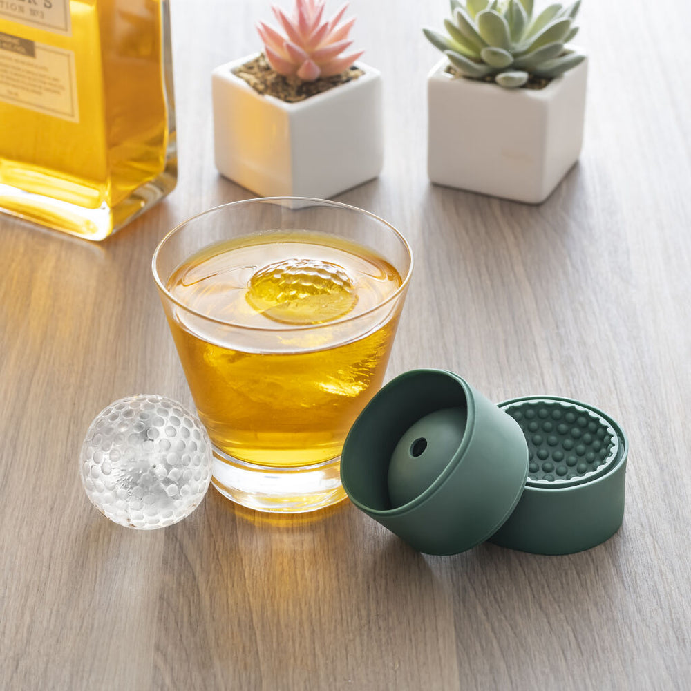 Kikkerland golf ball-shaped ice mold from Cornucopia Home and Gift, showing the silicone mold with ice balls inside.