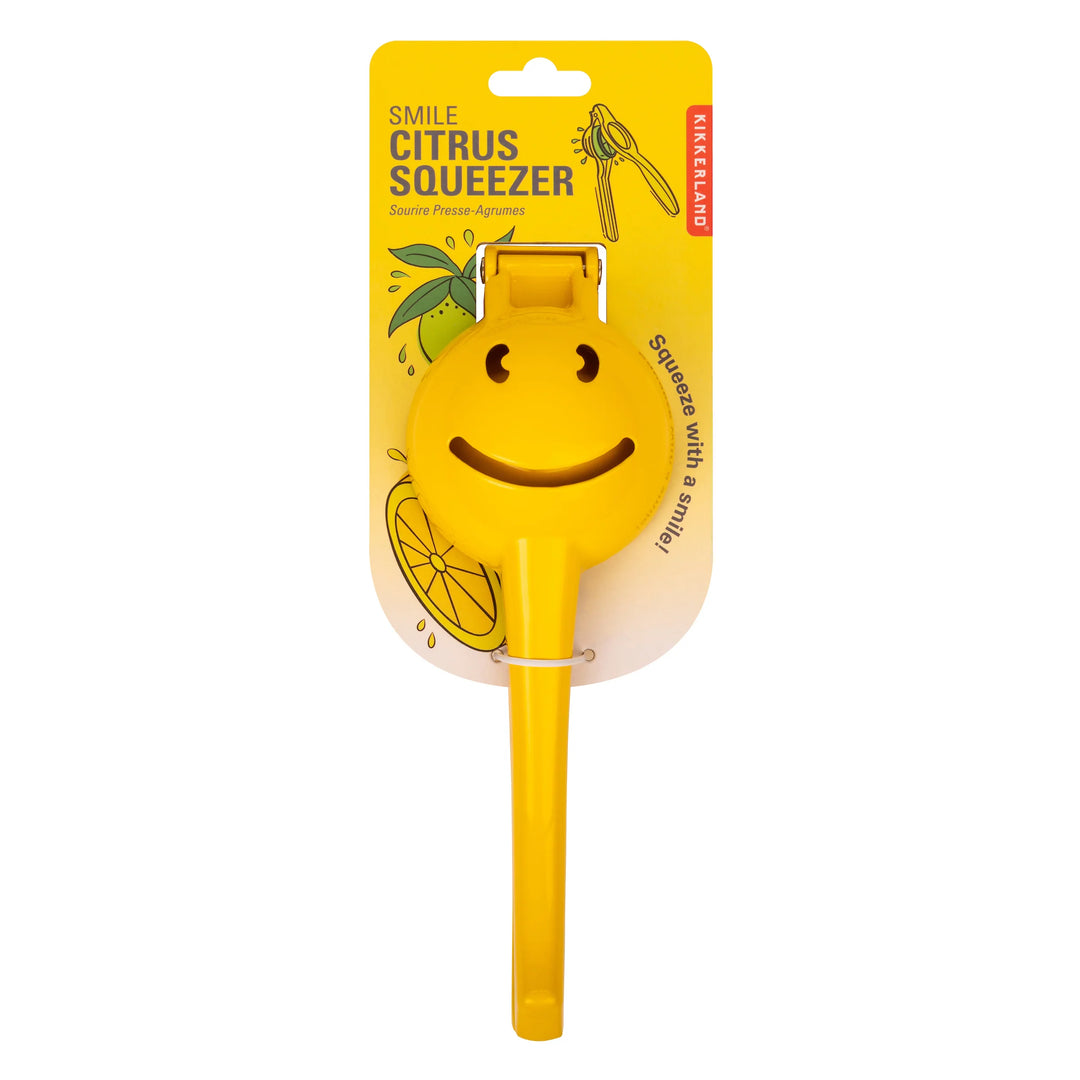 Kikkerland Smiley Face Citrus Squeezer in packaging, bright yellow design for easy juicing of lemons and oranges.