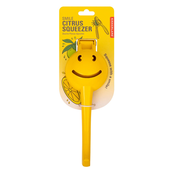 Kikkerland Smiley Face Citrus Squeezer in packaging, bright yellow design for easy juicing of lemons and oranges.