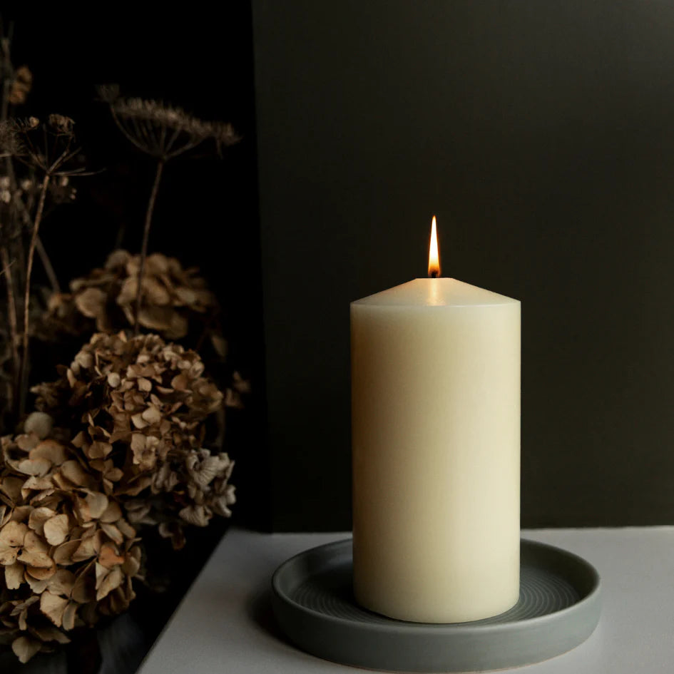 St Eval 4x8 inch church candle with white wax and a simple wick, suitable for religious or decorative purposes.