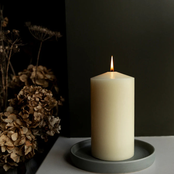 St Eval 4x8 inch church candle with white wax and a simple wick, suitable for religious or decorative purposes.