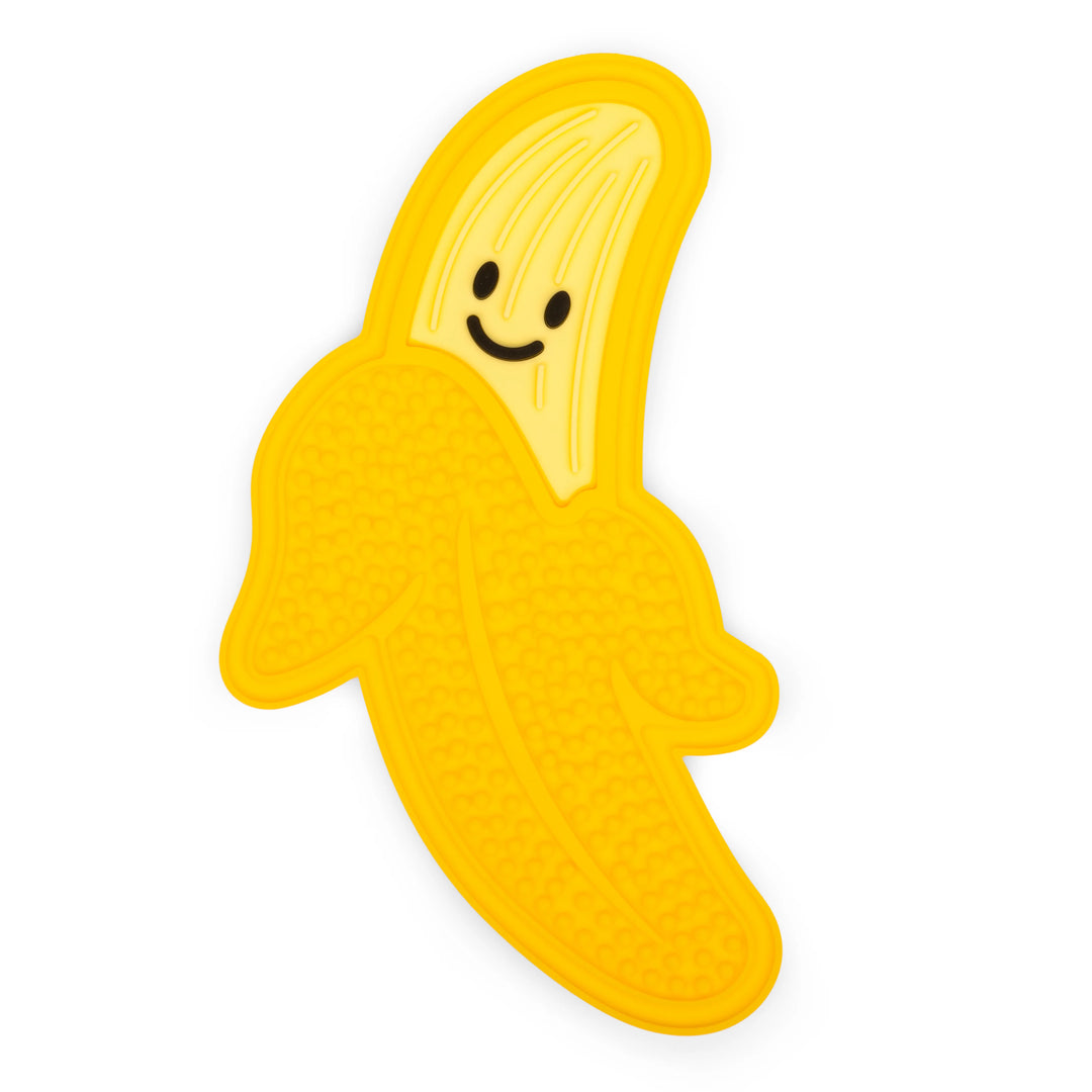 White Kikkerland Banana Lick Mat for pets, made by Cornucopia Home and Gift, with textured surface for engaging pet licking fun.