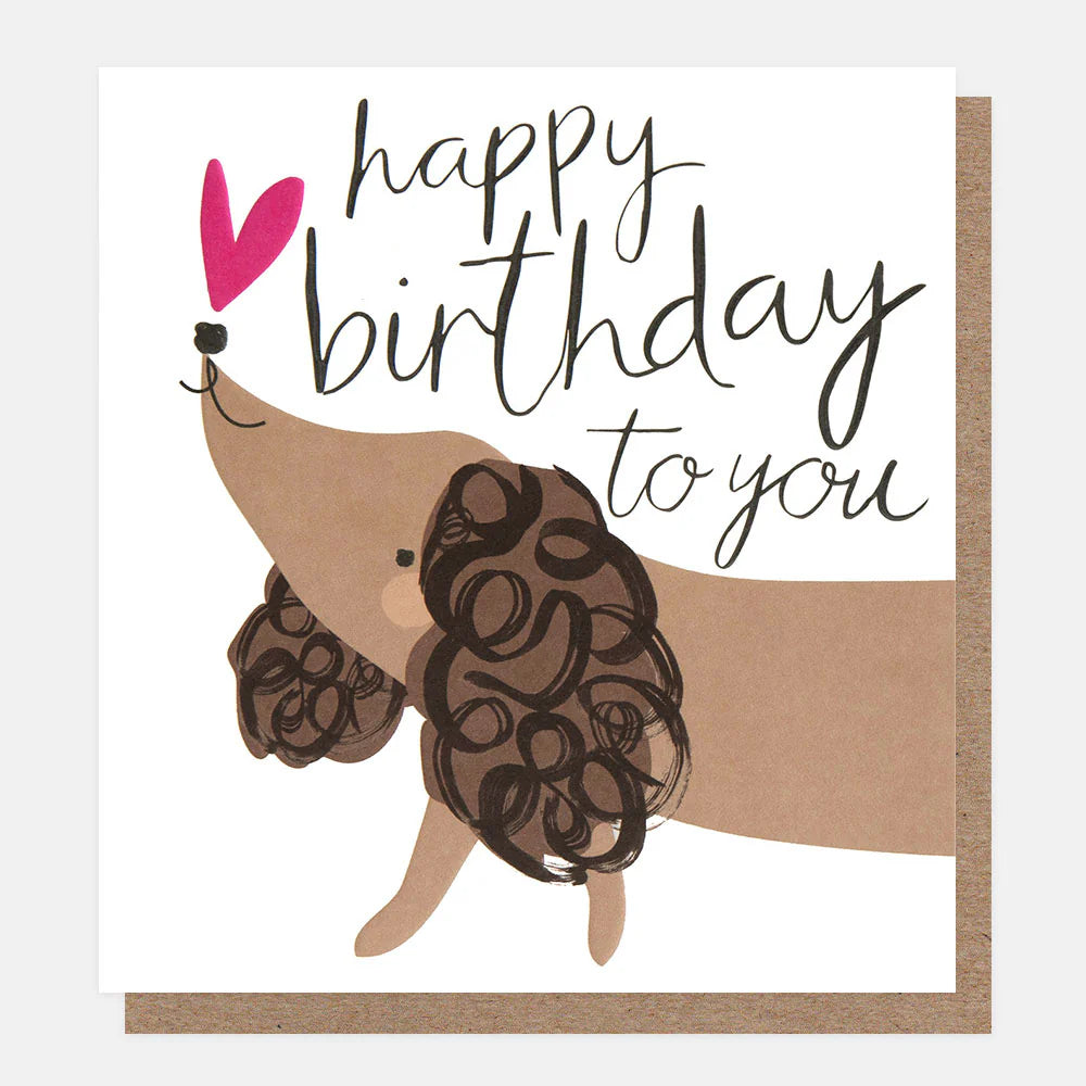 Caroline Gardner Happy Birthday sausage dog with doodle ears illustration on a greeting card, featuring cheerful birthday design.