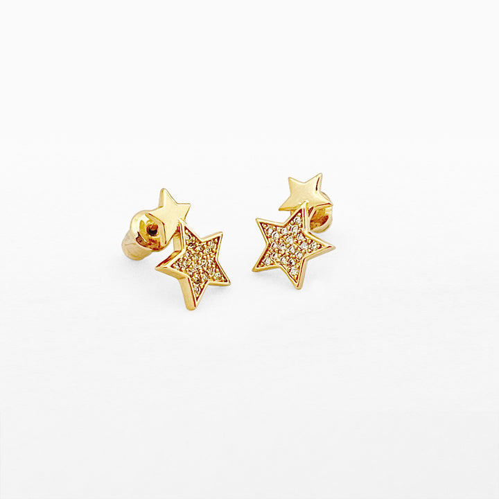 Double gold star stud earrings from Life Charms by Cornucopia Home and Gift, featuring shiny gold star designs on a white background.