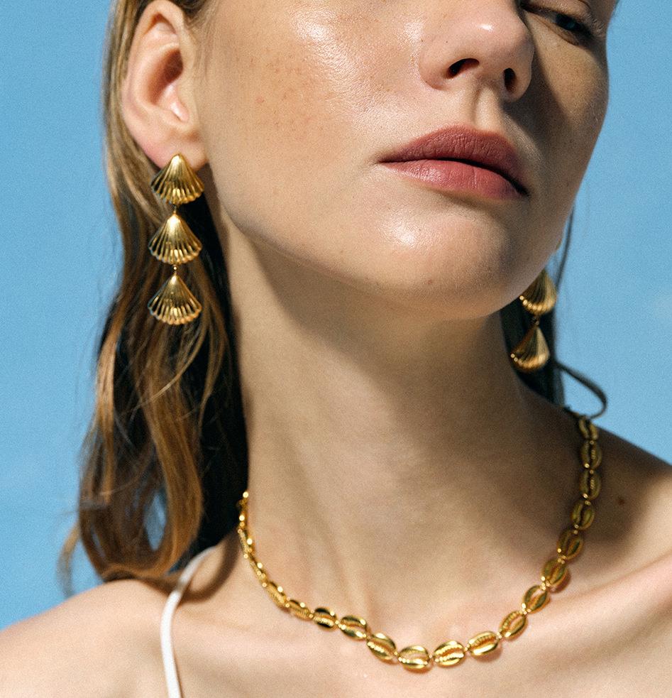 Gold triple drop shell earrings with white leaf design, featuring elegant shell accents and a delicate gold finish.