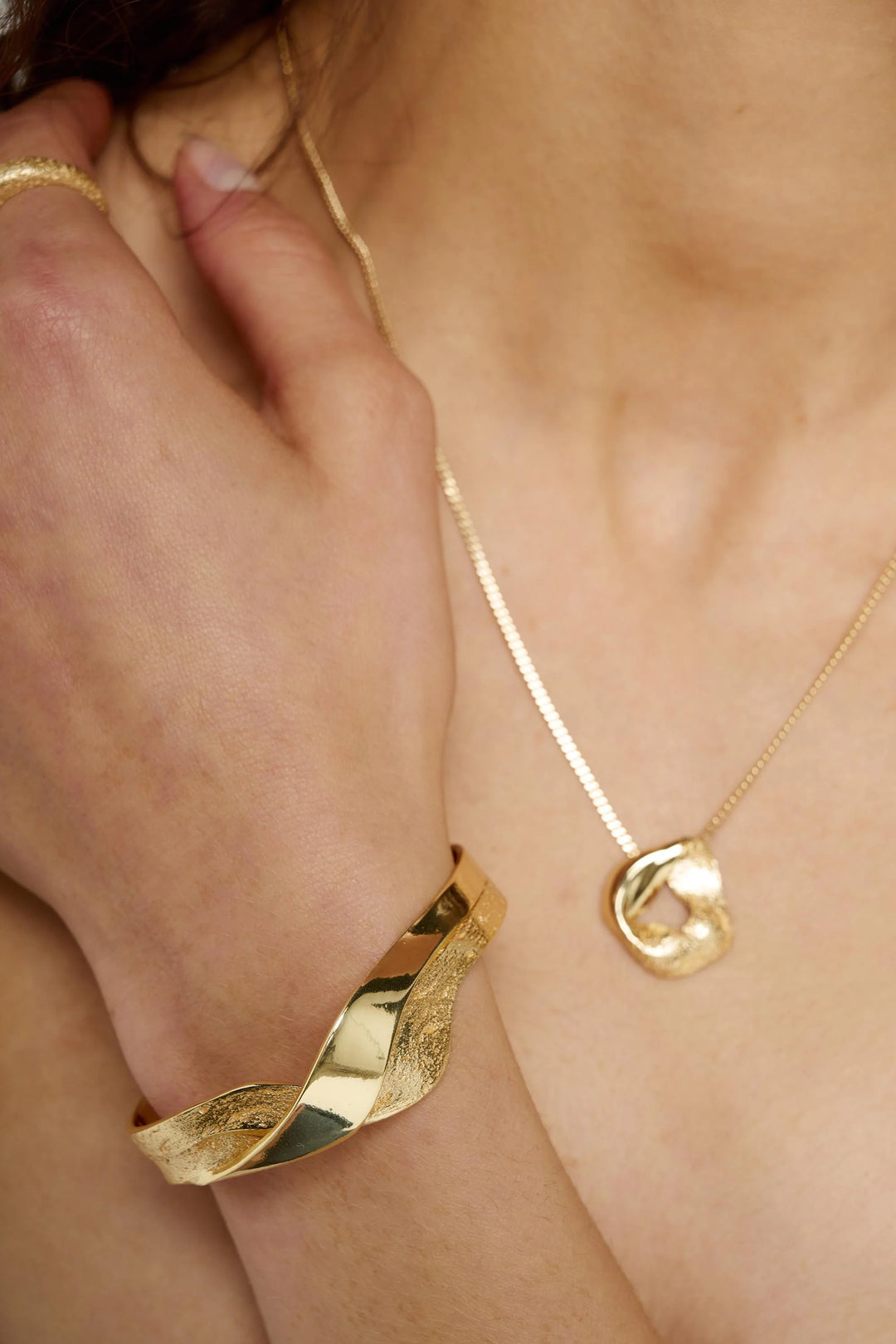 Gold Wave Bangle by Tutti &amp; Co, featuring a sleek, wavy design perfect for elegant jewelry styling.