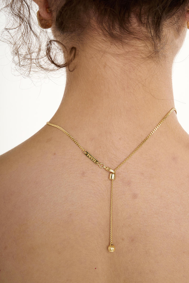 Gold Halo Necklace by Tutti &amp; Co featuring a delicate circular pendant, styled on a neutral background.
