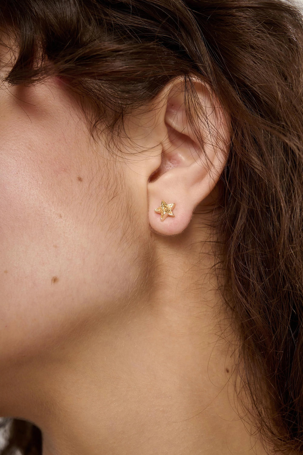 Gold Cosma Earrings by Tutti & Co featuring sleek, modern design with gold finish, displayed on a neutral background.