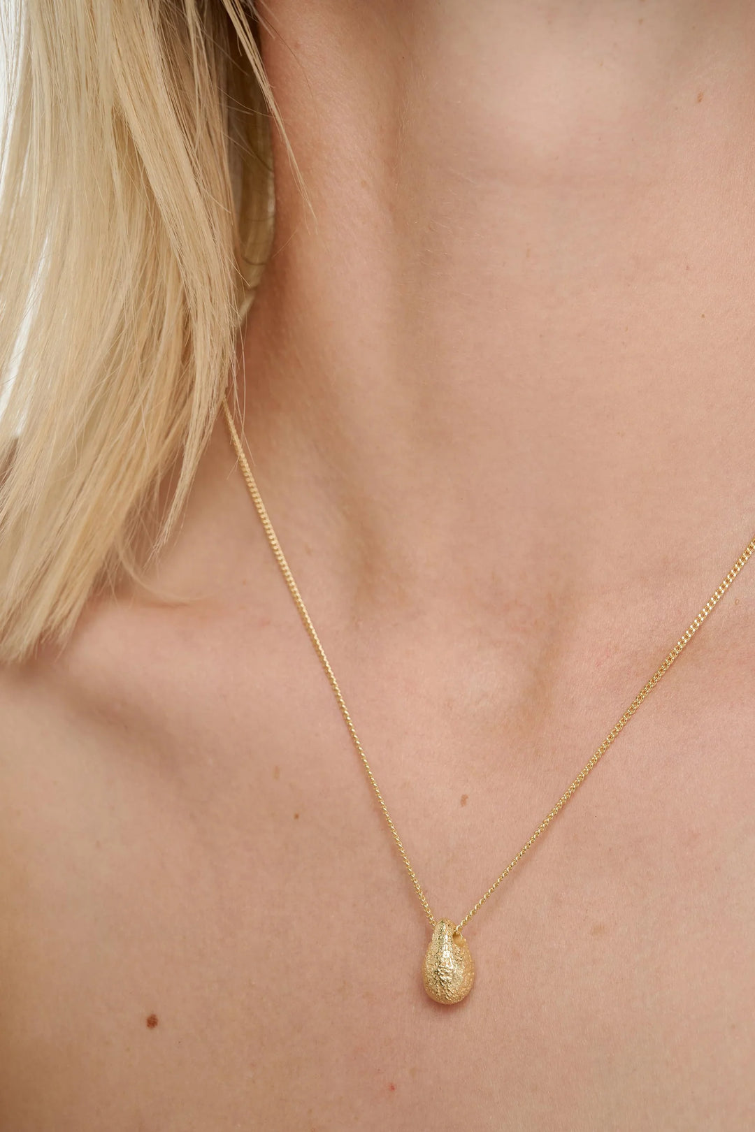 Gold dome necklace by Tutti &amp; Co featuring a smooth, rounded pendant on a delicate chain.
