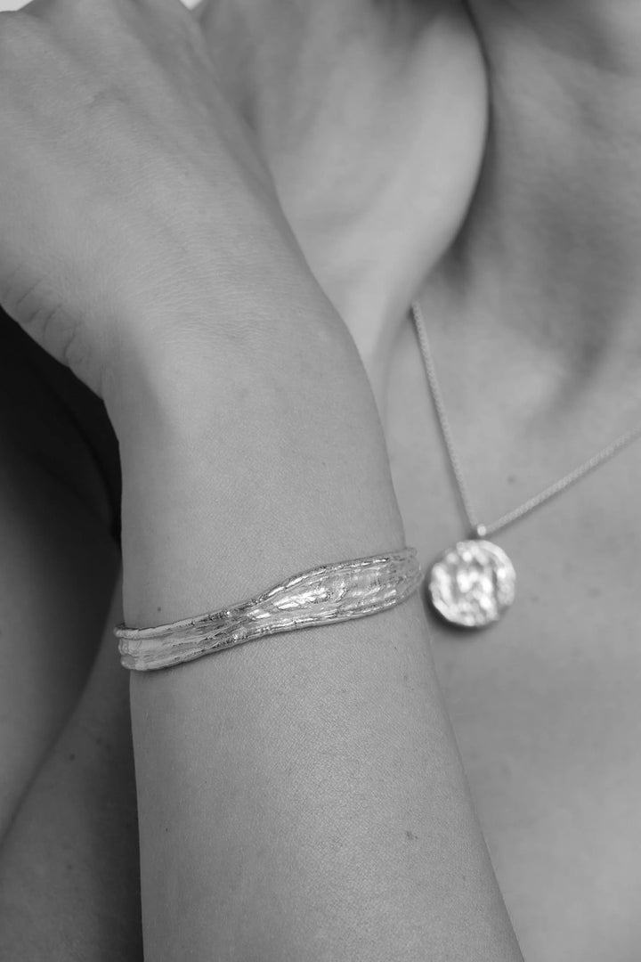 Silver Driftline Bangle by Tutti &amp; Co featuring a sleek, modern design, displayed on a neutral background.