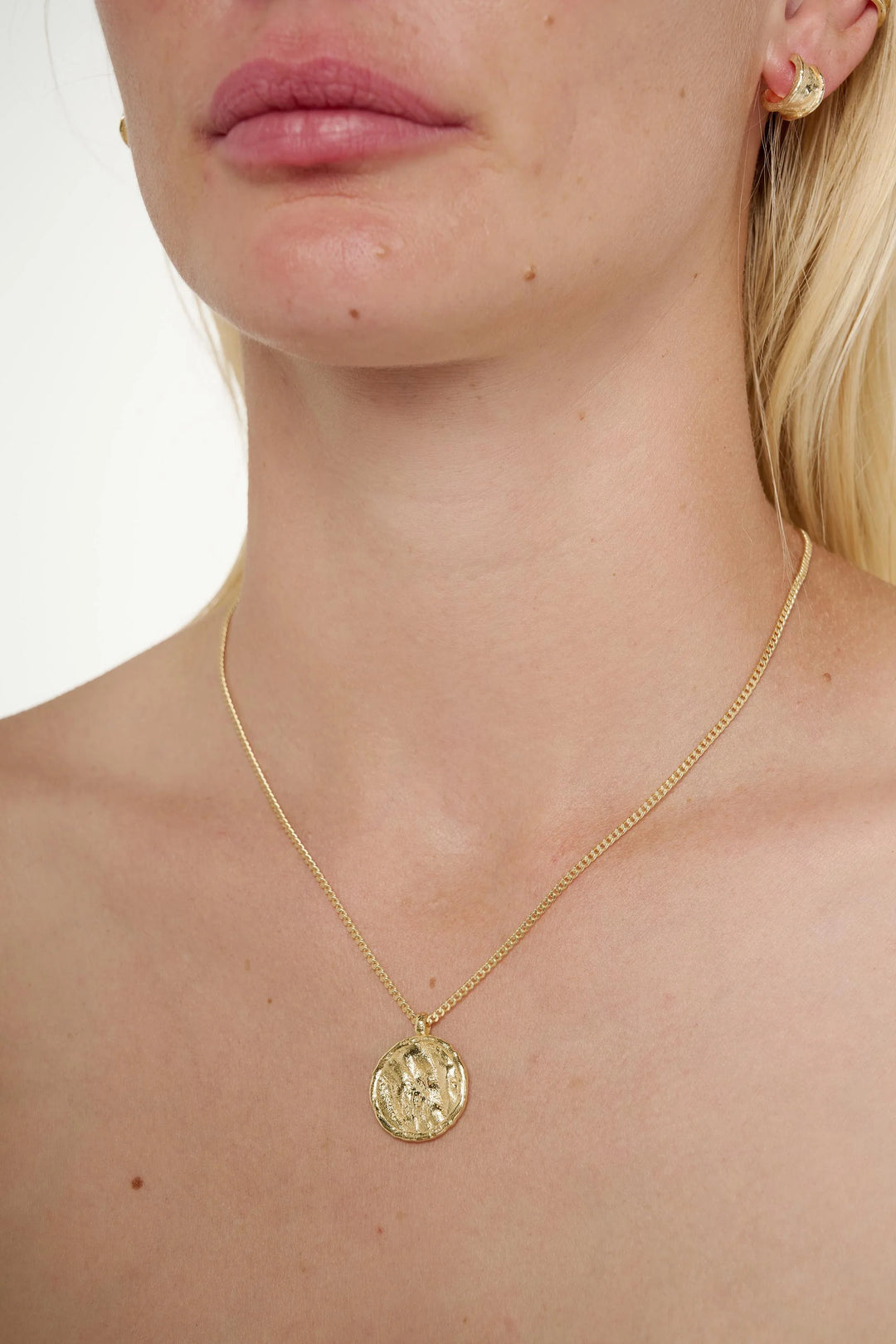 Gold Arc Necklace by Tutti &amp; Co featuring a sleek, minimalist design, displayed on a neutral background.
