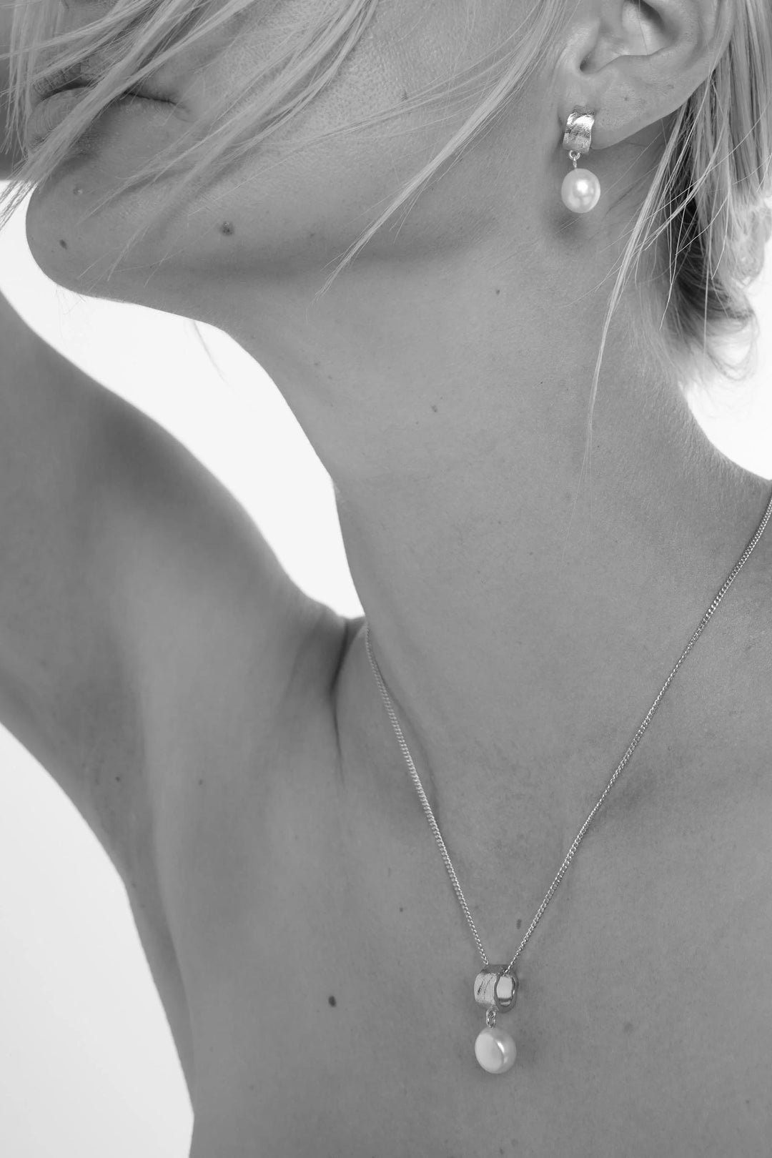 Elegant freshwater pearl necklace by Tutti &amp; Co featuring silver clasps, displayed on a neutral background.