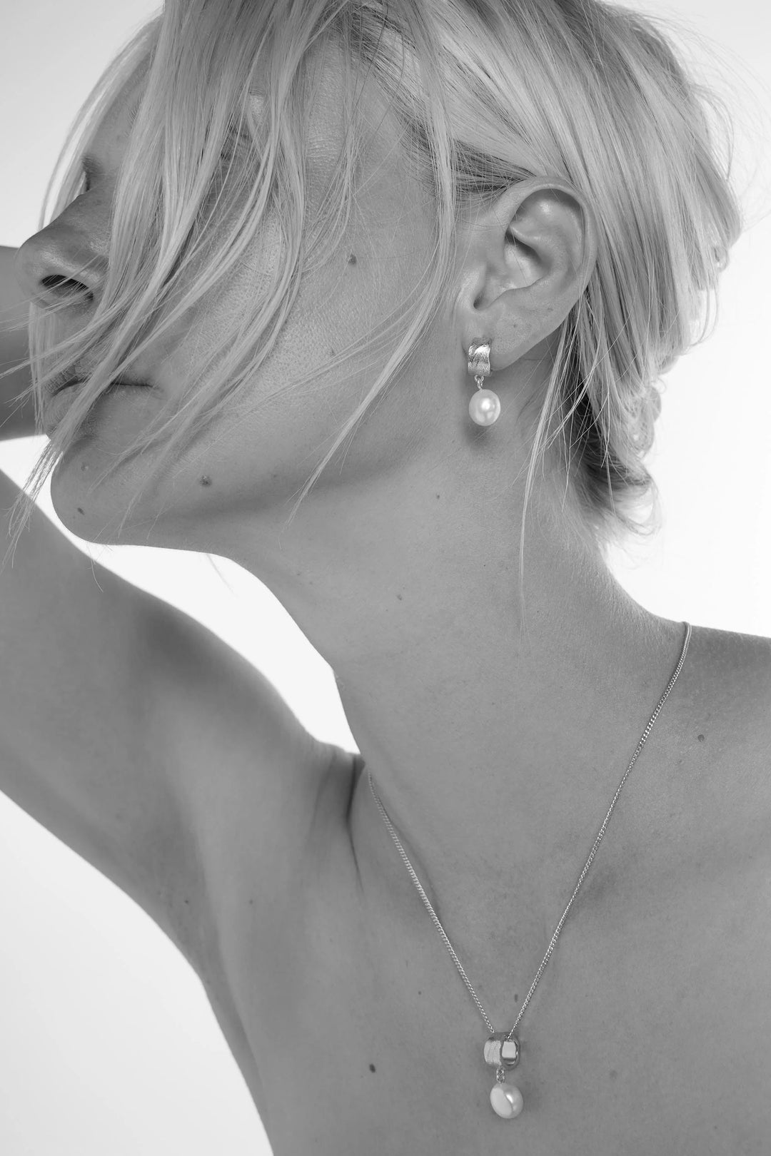 Silver freshwater pearl earrings by Tutti &amp; Co featuring elegant, lustrous pearls on delicate silver hooks.