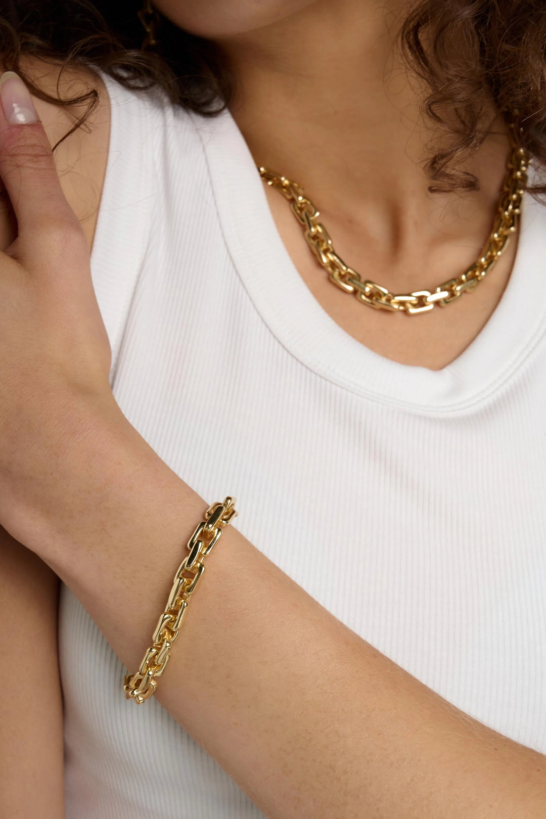 Tutti &amp; Co link bracelet with silver-tone chain and intricate link design, displayed on a neutral background.
