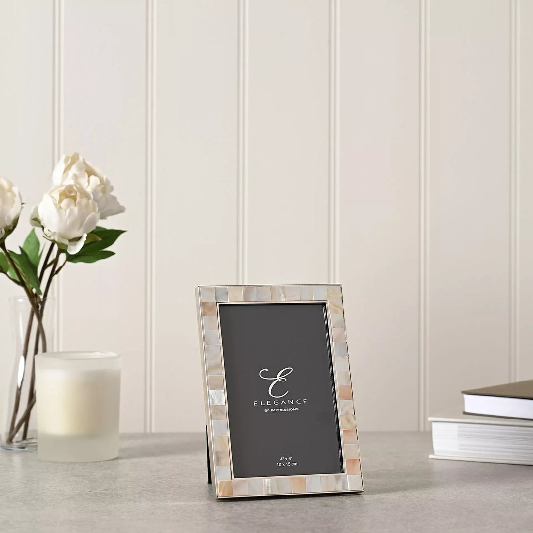 Elegant metal photo frame with mother of pearl inlay by Widdop &amp; Co, designed for 4x6 inch pictures.