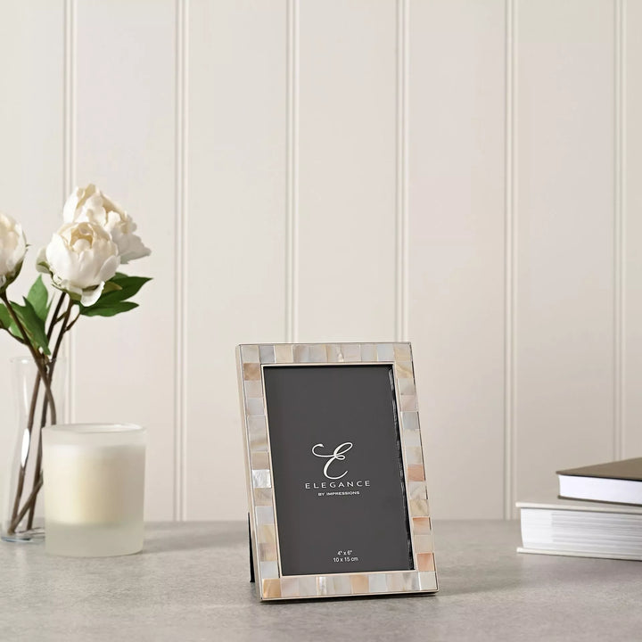 Elegant metal photo frame with mother of pearl inlay by Widdop &amp; Co, designed for 4x6 inch pictures.