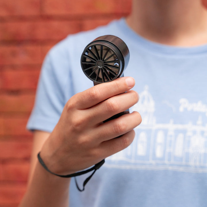 Kikkerland mini black fan from Cornucopia Home and Gift, compact handheld fan with a sleek design for personal cooling.