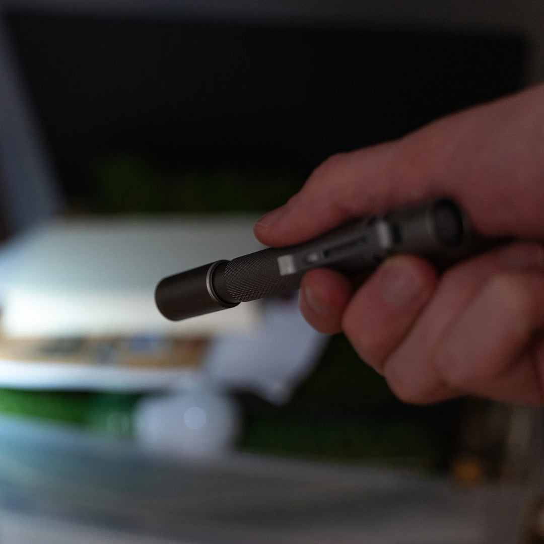 Kikkerland Pocket Flashlight by Cornucopia Home and Gift, compact handheld flashlight with black casing and LED bulb.