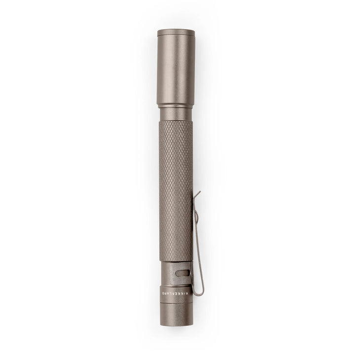 White pocket flashlight by Kikkerland on a plain background, compact and portable LED flashlight for everyday use.