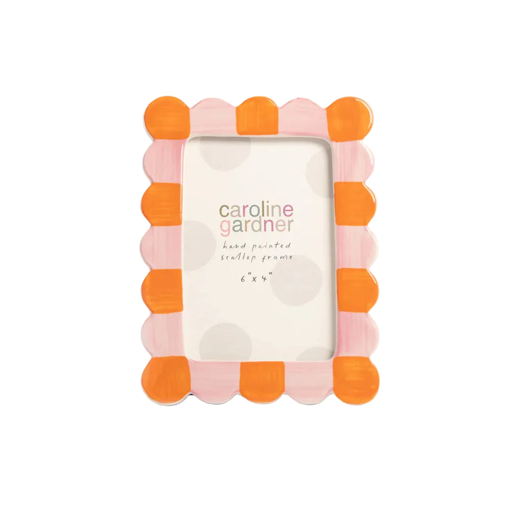 Decorative picture frame with orange and pink scalloped design on a light gray background