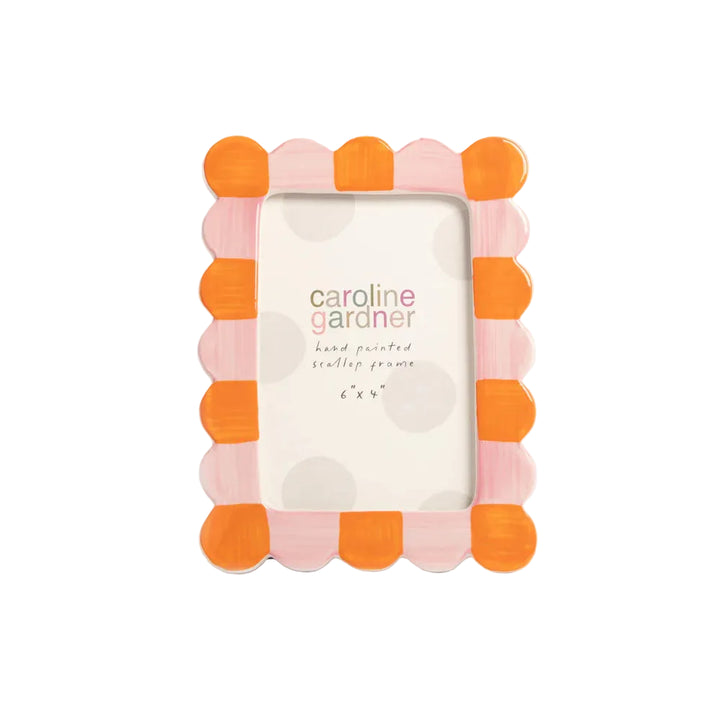 Decorative picture frame with orange and pink scalloped design on a light gray background