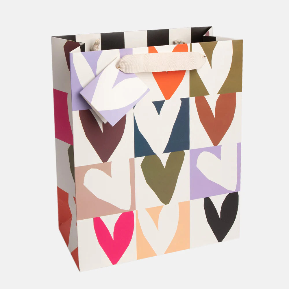 Large Caroline Gardner gift bag with a colorful multi-checkmate heart print, perfect for special occasions and gift wrapping.